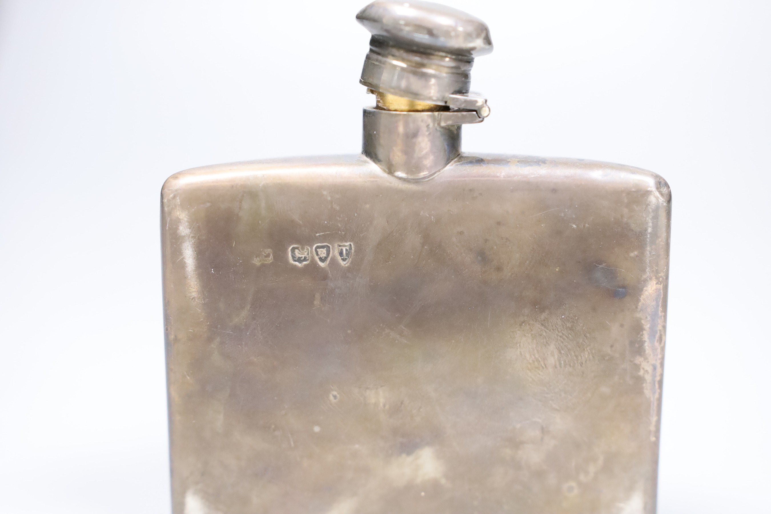 A Victorian silver hip flask with lockable cap, engraved Hogg family crest, London 1894, together with a cased part-set of five silver coffee spoons, Sheffield. 1923